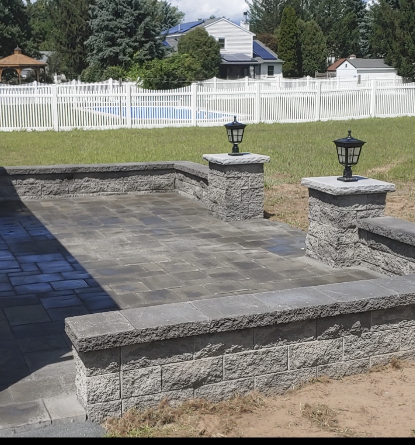 Paver patio with seat wall and pillar lights