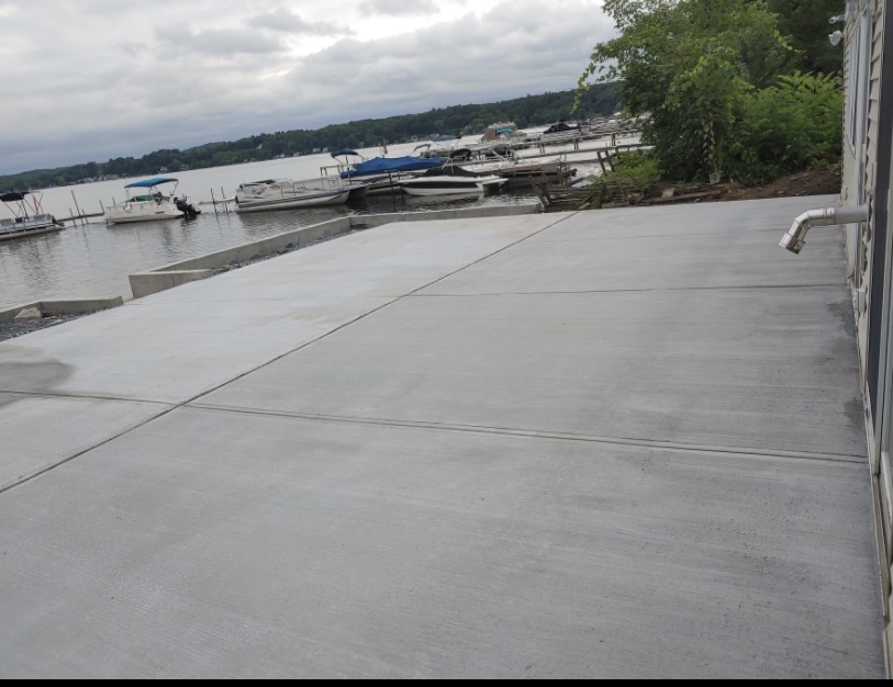 Broom finish concrete pad by the lake