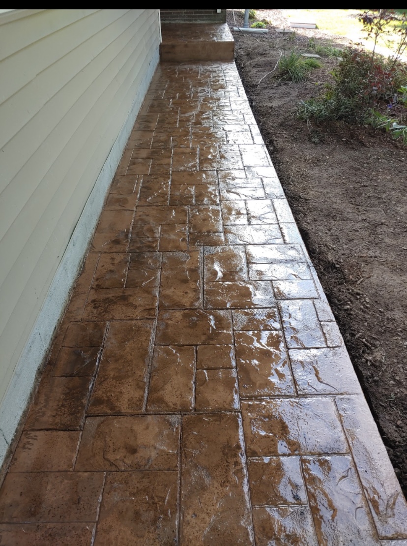 Stamped concrete walkway alongside home